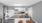 a kitchen with a bar stool and a washing machine