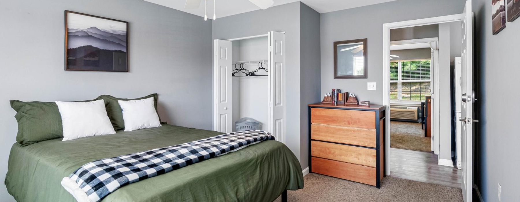 a bedroom with a bed and a fan