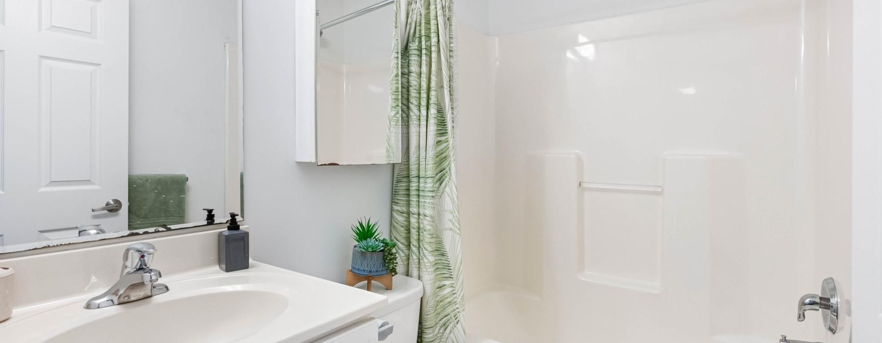 a bathroom with a shower and sink